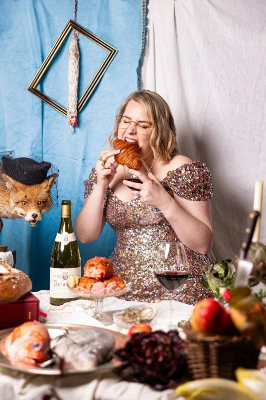 Caroline Fazeli biting into a croissant